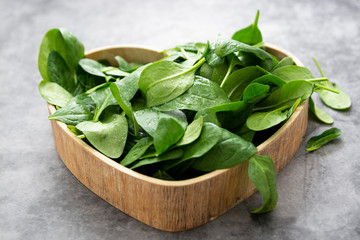 Fresh spinach leaves or spinach salad close up, background