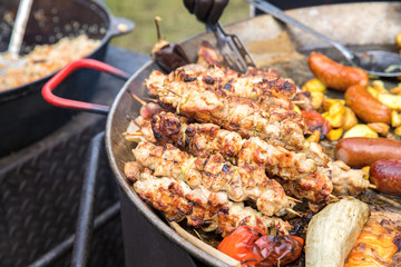 Kebabs of meat in a large pan. Close up.