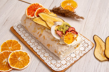 Juicy sliced meringue cake with dried fruits