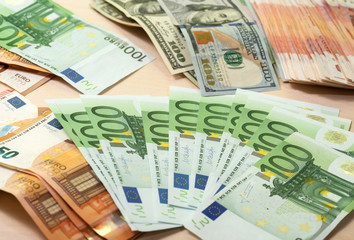 Heap of green houndred euro banknotes on the table