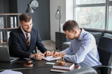 Male lawyer working with client in office