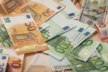 Obraz na płótnie Canvas Background of dollar, euro banknotes on a table