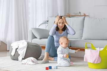 Young woman suffering from postnatal depression at home