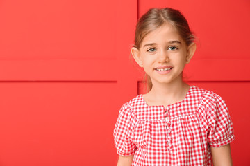 Happy little girl with healthy teeth on color background