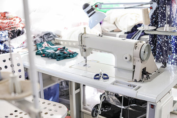Modern sewing equipment in tailor workshop