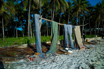 Fototapeta na wymiar Fishing nets are dried on the sandy seashore in Kenya, Africa.