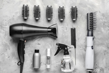 Modern hairdresser tools on grey background