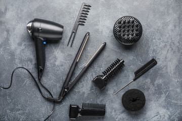 Modern hairdresser tools on grey background