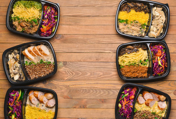 Containers with healthy food on wooden background