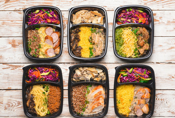 Containers with healthy food on wooden background