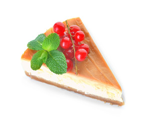 Slice of sweet caramel cheesecake with berries on white background