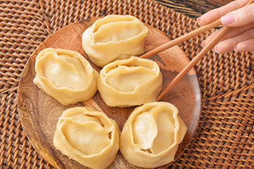 Eating of tasty oriental dumplings, closeup