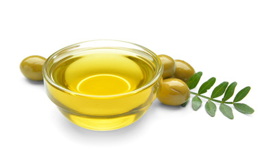 Bowl of tasty olive oil on white background