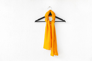 Hanger with beautiful scarf on white background