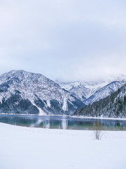 Lake plansee in austria during winter snow