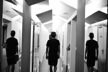 man walking with mirror reflection black & white