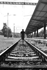 man walking Black & white railroad train