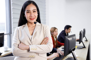Portrait of happy and confident Asian woman call center operator agent at office. Concept for customer support service, lifestyle at office, employee.