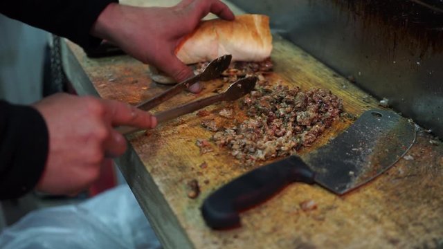 "Kokorec" preparation between bread is a dish made from the small intestine of sheep in Anatolia and the Balkans.