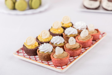 Tasty cupcakes on a white wooden table 
