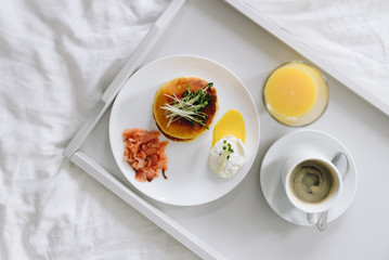 Top view of nutritious and tasty breakfast in bed on tray top view