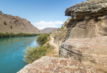 rocky landscape along Roxburgh Gorge with Clutha River in Central Otago, New Zealand