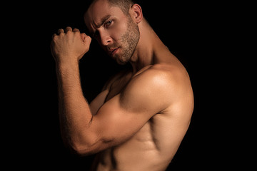 Handsome sport sexy stripped guy portrait for cosmetics and fitness drops on isolated black...