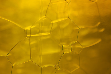 Macro image of a surface with ocher colored bubbles