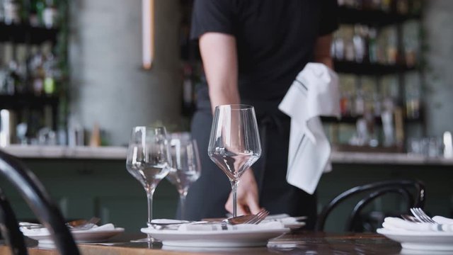 Close Up Of Male Waiter Polishing Cutlery On Table Before Service In Bar Restaurant - Shot In Slow Motion