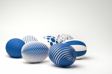 Easter Eggs with different textures in classic blue on a seamless white background. Selective focus...