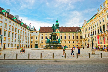 Fototapeta na wymiar Tourists at Amalienburg and inner courtyard in Vienna