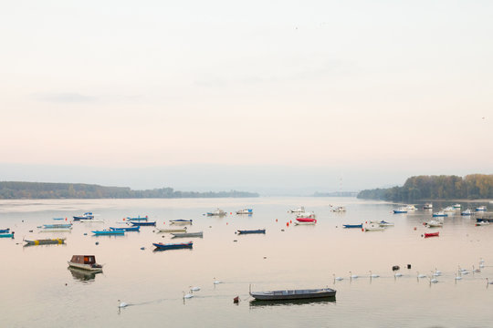 Zemun Quay (Zemunski Kej) in Belgrade, Serbia, on the Danube river, seen in autumn, during the afternoon. Boats can be seen in front, and Belgrade center in background