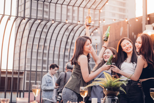 Group of Attractive young Asian cute women having a party. Girls drinking beer and feeling happy enjoy, with funny smiley faces. Party on holiday and Night lifestyle concept.
