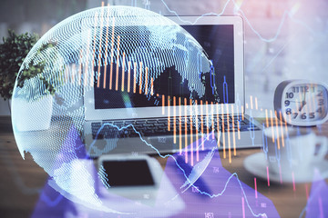 Financial chart drawing and table with computer on background. Multi exposure. Concept of international markets.