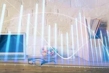 Financial chart drawing and table with computer on background. Double exposure. Concept of international markets.