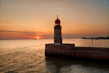 historic lighthouse on the pier Geestemole in Bremerhaven (Germany) during a scenic sunset