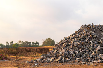 Pile of numerous granite blocks on the ground.