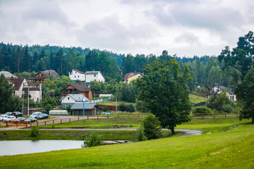 A view from above on a panorama of cottages by the river. Mountain landscape