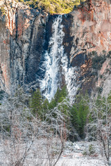Fototapeta na wymiar Beautiful view of Yosemite Winter Wonderland from the Valley with snow, Mountains and beautiful trees at Yosemite National Park, California, United States of America.