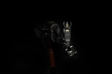 The barrel of a Kalashnikov AK-47 assault rifle on a black background