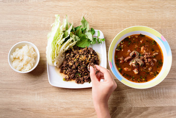 Traditional Northern Thai food, spicy minced pork salad (Larb Moo Kua) and spicy Thai curry soup...