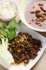 Traditional Northern Thai food, spicy minced pork salad (Larb Moo Kua) and spicy Thai curry soup with beef guts (Kaeng Om Nua) eating with sticky rice