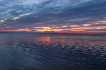 Fototapeta na wymiar background. Beautiful sunrise / sunset on the sea / lake / river. heavy clouds with an orange tint.