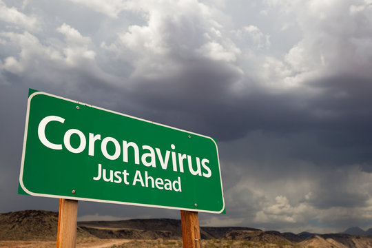 Coronavirus Green Road Sign Against Ominous Stormy Cloudy Sky