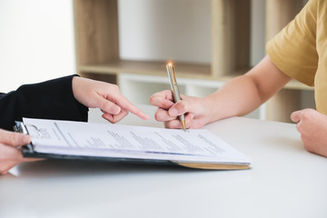 Business woman and partner sign a contract investment professional document agreement in meeting room.