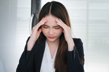 Female employees show headaches from work or disappointment from work. Health and care concept