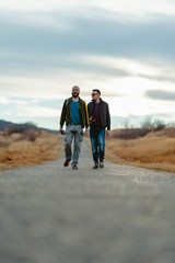 Friends hiking down the road © kerkezz