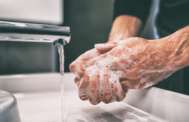 Coronavirus pandemic prevention wash hands with soap warm water and , rubbing nails and fingers washing frequently or using hand sanitizer gel.