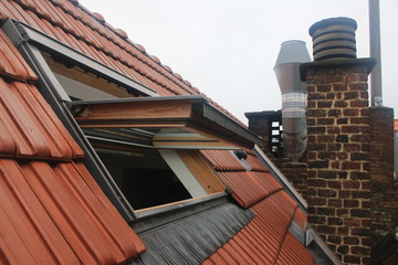 Open window in the roof on the top floor of a building, welcoming thieves to break in