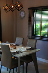 dish ware sets arrange on dining table inside eating room of modern home interior